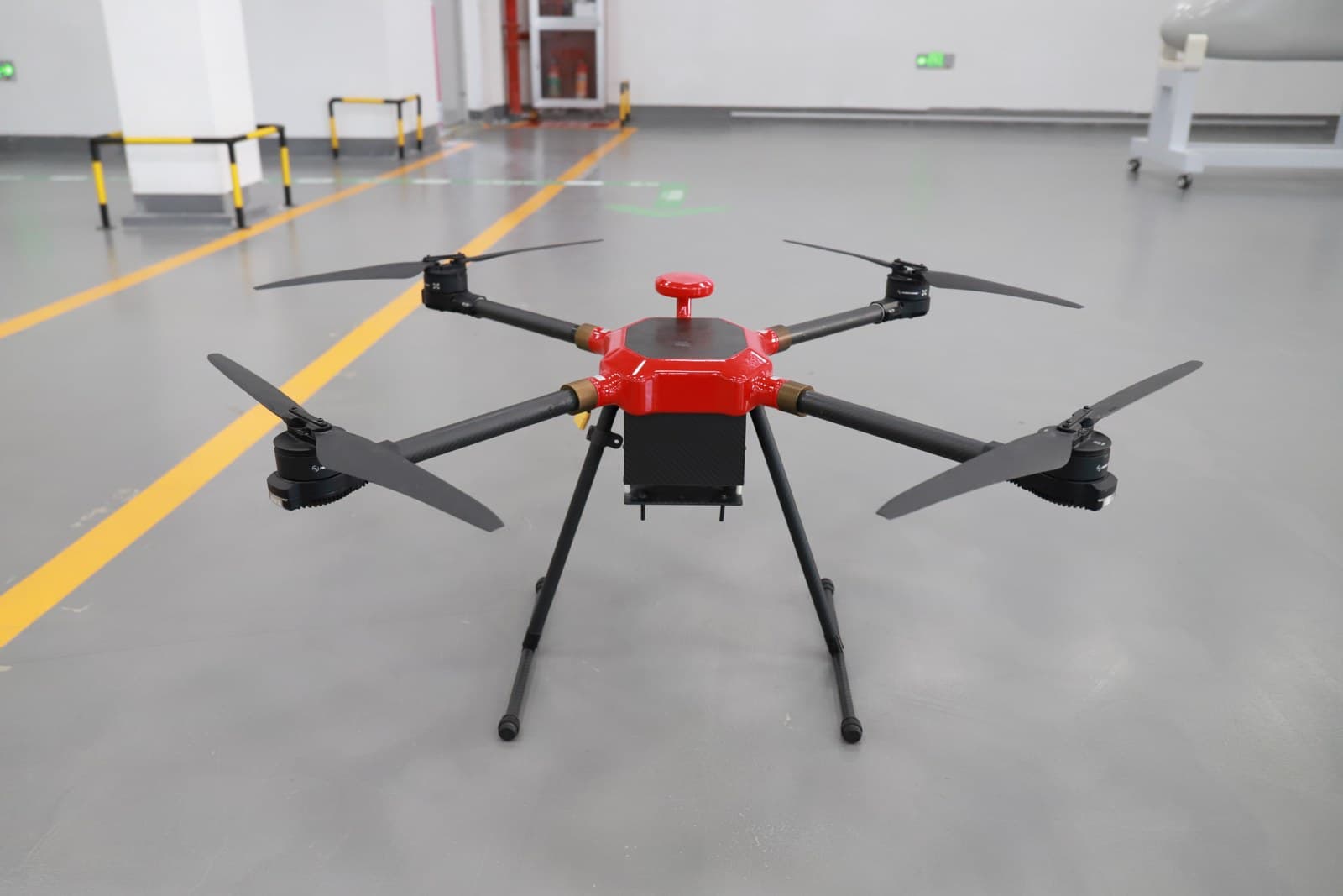 Red quadcopter inspection UAV on the test floor