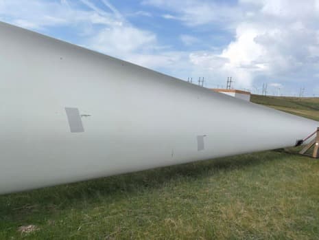 Wind turbine blade laid out on site for inspection